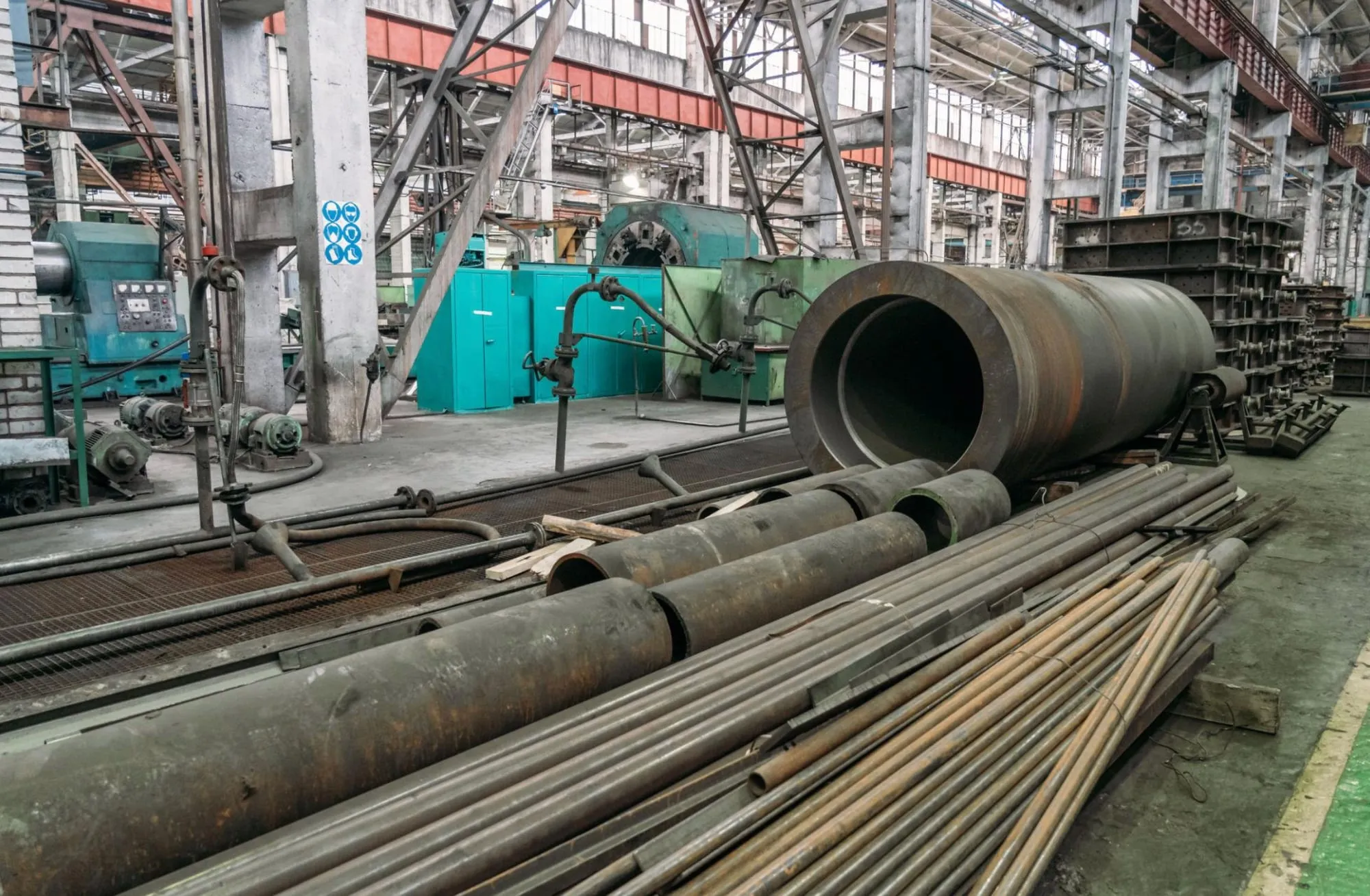 Large steel pipes in an industrial workshop